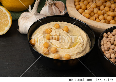 Hummus in bowl, houmous dip, chickpea humus tahini sauce, middle eastern spread Hummus in bowl, houmous dip, chickpea humus tahini sauce, middle eastern spread 133050176