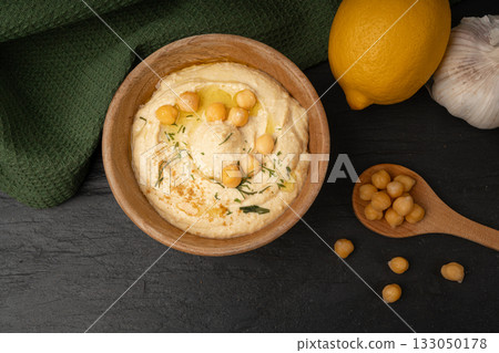 Hummus in bowl, houmous dip, chickpea humus tahini sauce, middle eastern spread Hummus in bowl, houmous dip, chickpea humus tahini sauce, middle eastern spread 133050178