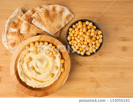 Hummus in bowl, houmous dip, chickpea humus tahini sauce, middle eastern spread Hummus in bowl, houmous dip, chickpea humus tahini sauce, middle eastern spread 133050191