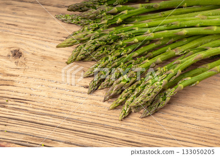 Bunch of Raw Garden Asparagus on Wood Rustic Tabletop. Fresh Green Spring Vegetables Bunch of Raw Garden Asparagus on Wood Rustic Tabletop. Fresh Green Spring Vegetables 133050205