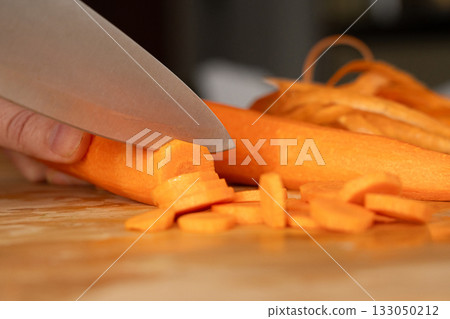 Cutting Fresh Carrot with Knife Close Up, Raw Carrot Slices Closeup, Orange Root Vegetable 133050212