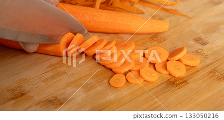 Cutting Fresh Carrot with Knife Close Up, Raw Carrot Slices Closeup, Orange Root Vegetable 133050216