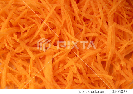 Fresh Finely Grated Carrots Textured Background, Raw Carrot Pieces Closeup Pattern 133050221