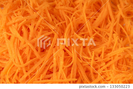 Fresh Finely Grated Carrots Textured Background, Raw Carrot Pieces Closeup Pattern 133050223