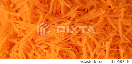 Fresh Finely Grated Carrots Textured Background, Raw Carrot Pieces Closeup Pattern 133050226