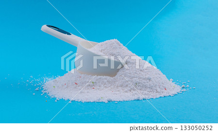 Detergent powder pile. Laundry washing soap granules, small white texture of oxygen bleach Detergent powder pile. Laundry washing soap granules, small white texture of oxygen bleach 133050252