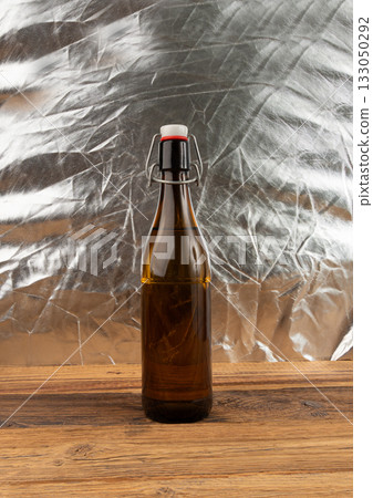 Old beer bottle, brown glass vintage beerbottle, a quality traditional time-tested drink symbol Old beer bottle, brown glass vintage beerbottle, a quality traditional time-tested drink symbol 133050292
