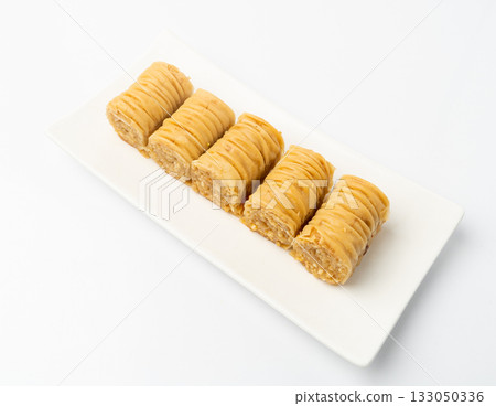 Rolled Baklava Isolated, Ramadan Dessert Roll on Restaurant Plate, Eastern Sweet Pastries 133050336