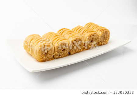 Rolled Baklava Isolated, Ramadan Dessert Roll on Restaurant Plate, Eastern Sweet Pastries 133050338