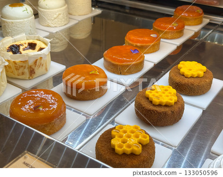 Meringue lemon tarts on pastry counter. Lightness, balance, and elegance of modern French-inspired dessert culture. 133050596