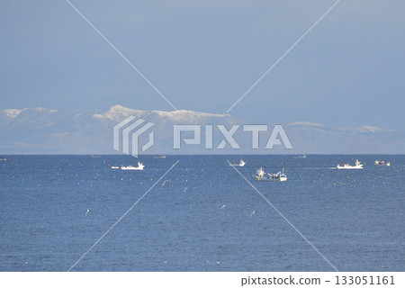 Photographed a scene of scallop fishing boats operating in Funka Bay in Yakumo Town, Hokkaido in early winter. 133051161