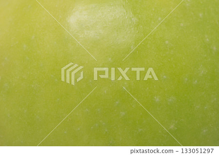 Texture of a green apple as a background macro photo. 133051297