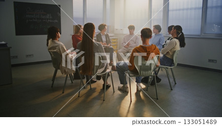 Teen Students Sit in Circle With Caring Teacher Discussing Psychology and Self Awareness Teen Students Sit in Circle With Caring Teacher Discussing Psychology and Self Awareness 133051489