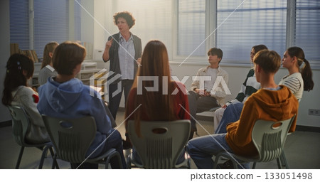 Female Teacher Guides Teenage Girl in Center of Circle Through Emotional Improvisation Exercise Female Teacher Guides Teenage Girl in Center of Circle Through Emotional Improvisation Exercise 133051498