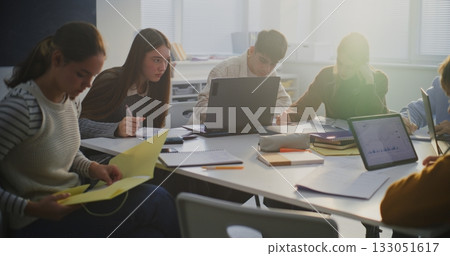 Group of Students Gathered Around Shared Workspace Group of Students Gathered Around Shared Workspace 133051617