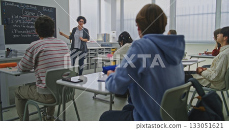 Focused Students Listen to Teacher Explaining Coding Assignment Focused Students Listen to Teacher Explaining Coding Assignment 133051621