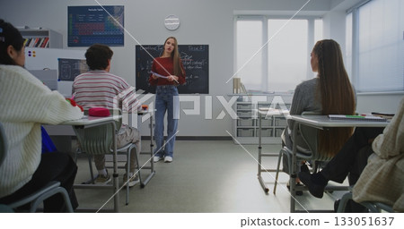Young Woman Student Giving Presentation In Modern Classroom Young Woman Student Giving Presentation In Modern Classroom 133051637