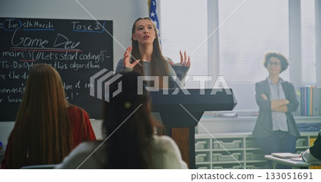American Teenage Girl Delivers Expressive Speech, Gesturing Confidently With US Flag 133051691