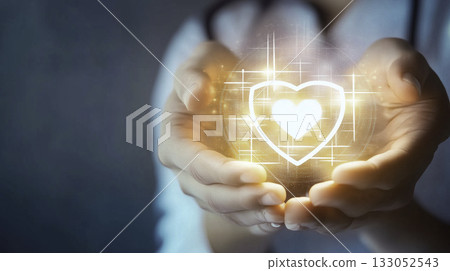 A dedicated healthcare professionals hands are gently holding a glowing medical cross symbol that signifies care A dedicated healthcare professionals hands are gently holding a glowing medical cross symbol that signifies care 133052543