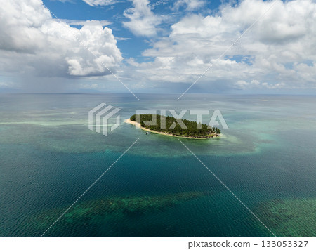 Tropical island covered with tall coconut trees and surrounded by sandy shore and clear sea. Siargao, Philippines. Casa Desideria. 133053327