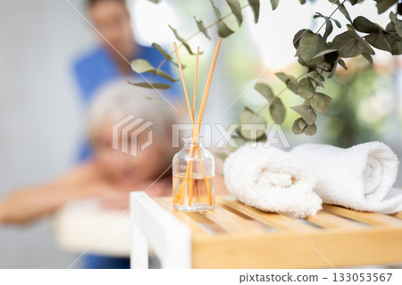Aroma diffuser and towels in interior of spa salon 133053567