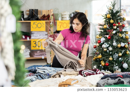 Asian woman chooses wool pants Asian woman chooses wool pants 133053623