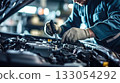 A car mechanic technician repairs a car in an auto repair shop. Generative AI. 133054292
