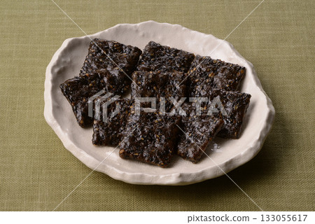Black sesame rice crackers on a Japanese plate 133055617