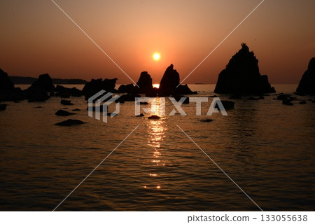 A rising sun on a bridge pile rock 133055638