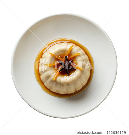 Inviting clove cremeux, silky spiced cream dessert with molasses drizzle, orange zest and star anise on plate 133056159