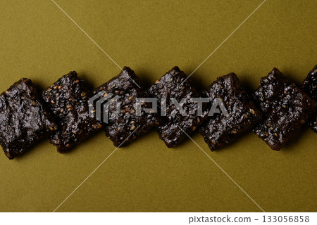 Black sesame rice crackers arranged in layers 133056858