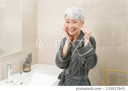 Senior woman in the bathroom (beauty and skin care) Senior woman in the bathroom (beauty and skin care) 133057641