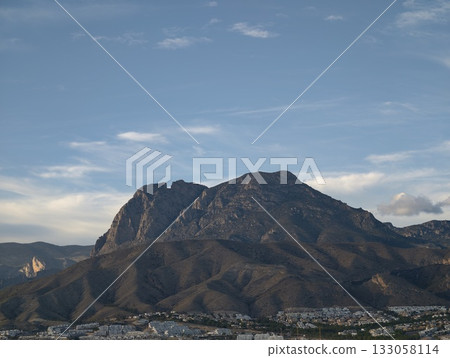 luminous mountain range provides panoramic views of charming local neighborhoods under blue sky 133058114
