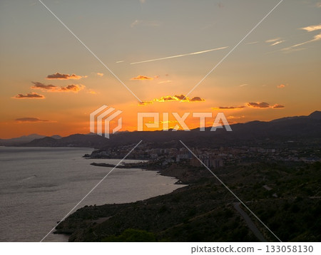 coastal evening with tranquil atmosphere, serene seaside view with glowing sunset and peaceful 133058130