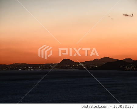 vivid sky landscape, bright horizon over peaceful waters, soothing sea scene with dramatic sunset 133058153