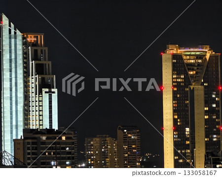 illuminated towers with vibrant lights, nighttime scene showcasing vibrant illuminated building 133058167