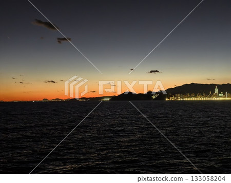 vibrant coastal evening landscape, dramatic sunset over illuminated bay with contrasting water vibrant coastal evening landscape, dramatic sunset over illuminated bay with contrasting water 133058204