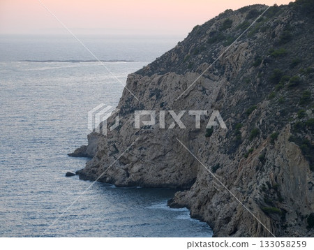 sunset bathes rugged rocks in gentle light, bold seaside landscape with dramatic cliffs and lively sunset bathes rugged rocks in gentle light, bold seaside landscape with dramatic cliffs and lively 133058259