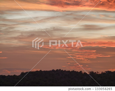 calm horizon with colorful clouds, soothing sunset view over gentle hills with expansive sky calm horizon with colorful clouds, soothing sunset view over gentle hills with expansive sky 133058265
