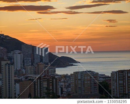 dramatic coastal skyline illumination, photographer captures warm golden hue over tranquil water dramatic coastal skyline illumination, photographer captures warm golden hue over tranquil water 133058295