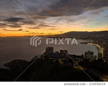 dusk bathes bay in amber glow, calm evening over bay with colorful sky and tranquil waters dusk bathes bay in amber glow, calm evening over bay with colorful sky and tranquil waters 133058314
