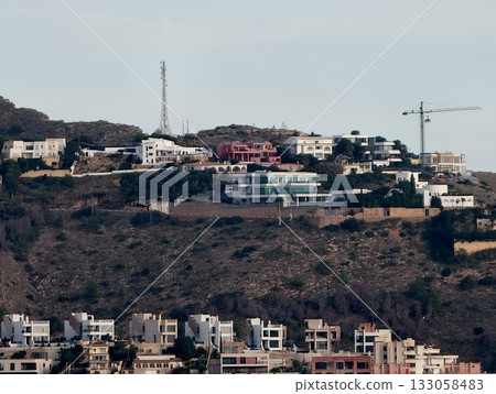 developing hillside villa communities, evolving residential area with cranes and scaffolding developing hillside villa communities, evolving residential area with cranes and scaffolding 133058483