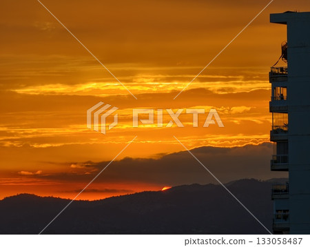 nighttime cityscape featuring apartment outline amidst blazing sunset and tranquil evening ambiance nighttime cityscape featuring apartment outline amidst blazing sunset and tranquil evening ambiance 133058487