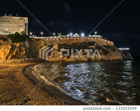 seaside evening scenery, luminous cliffs by night, moonlit coast with sparkling waves and promenade seaside evening scenery, luminous cliffs by night, moonlit coast with sparkling waves and promenade 133058504