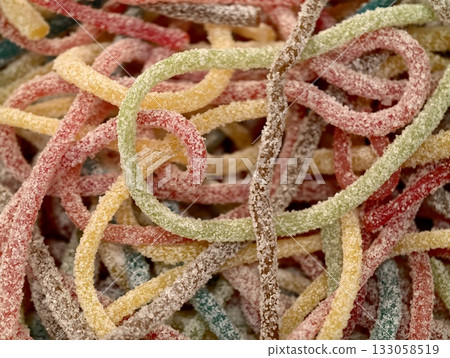 brightly colored chewy candy ropes, confectioner prepares shelves showcasing retro candy 133058519