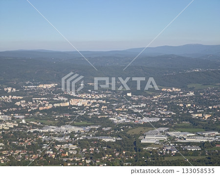 clusters of storage facilities and transportation connections outline landscape near forest edge 133058535