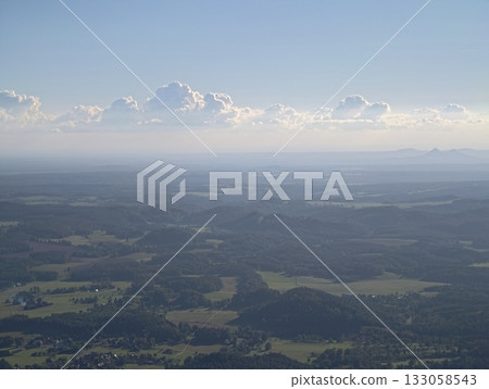 serene outdoor scenery with clouds and fields, tranquil aerial view of countryside with hills 133058543