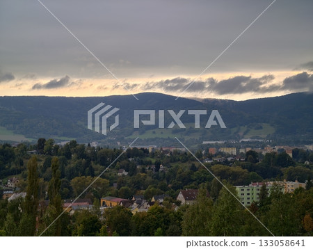 distant hills and peaceful town, photographer captures tranquil sunset with rolling hills 133058641
