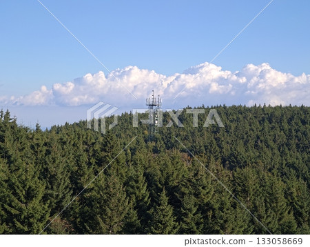 tower amidst treetops, engineered tower stands out among lush natural treeline with functional 133058669