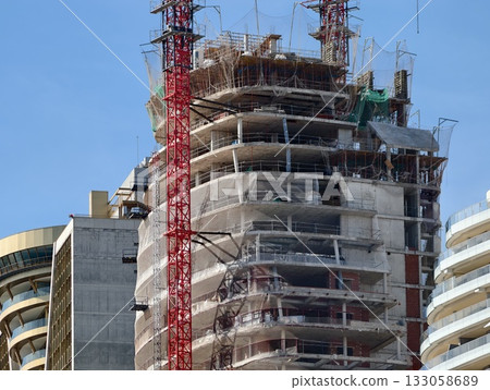 vertical living structure in city environment with detailed facade and construction activities vertical living structure in city environment with detailed facade and construction activities 133058689